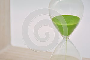 Green hourglass, counting time photo