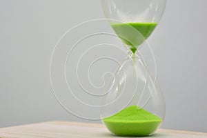 Green hourglass, counting time photo
