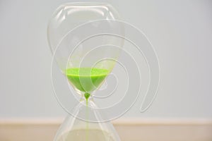 Green hourglass, counting time photo