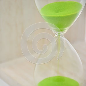 Green hourglass, counting time photo