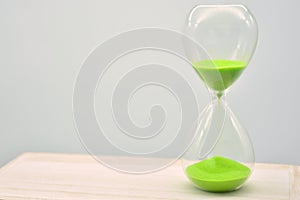 Green hourglass, counting time photo