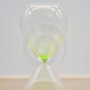 Green hourglass, counting time photo