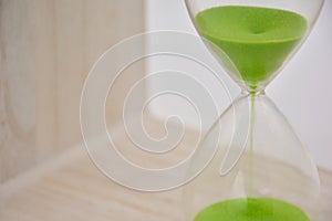 Green hourglass, counting time photo