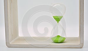 Green hourglass, counting time photo