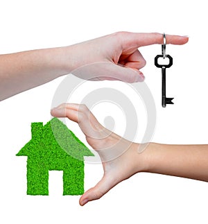 Green house with key in hands