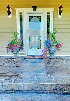 Green house with white door entrance.