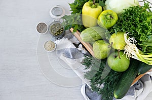 Green hypoallergenic vegetables in wooden box and the seeds. Vegetarian food. Selective focus, top view