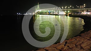 Green illuminated bridge in the bay of CÃÂ¡diz. photo