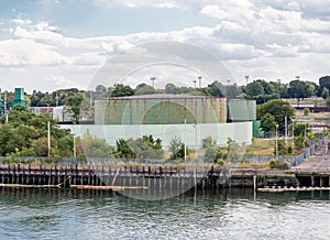 Green Industrial Tanks at Edge of Bay