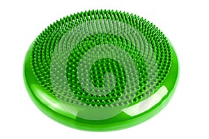 Green inflatable balance disk isoleated on white background, It is also known as a stability disc, wobble disc, and