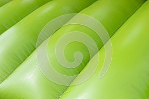 Green inflatable trampoline. Obstacle course. Details of amusement park