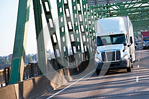 Green interstate bridge with commertial freight semi trucks on h