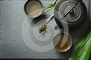 Green japanese tea on black slate background. Top view with copy space.