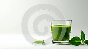 Green juice in glass with fresh leaves on white background. Healthy eating concept.