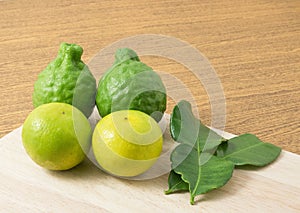 Green Kaffir Lime with Lemon Lime on Cutting Board