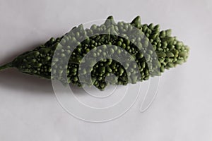 Green karela on a white background