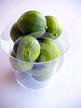 Green key limes in a clear cup