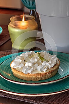 Green keylime pie dessert on a blue plate
