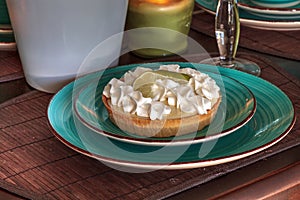 Green keylime pie dessert on a blue plate