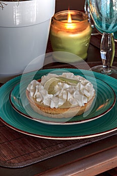 Green keylime pie dessert on a blue plate