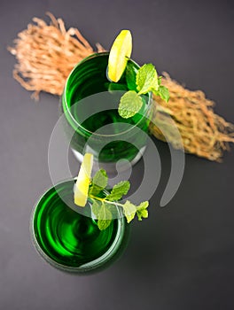 Green KHUS Sharbat or Vetiver grass extract or Chrysopogon zizanioides served in tall glass