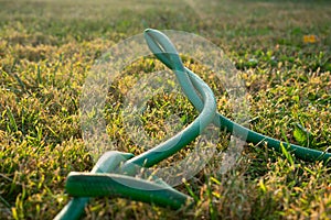 A green kinked garden hose