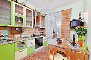 Green Kitchen interior with many utensils