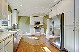 Green kitchen room with white storage combination