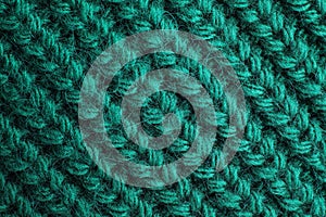 Green knitted sweater as background, closeup