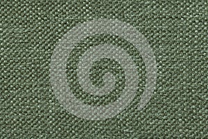Green knitted woolen background with a pattern of soft, fleecy cloth. Texture of textile closeup.