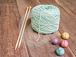 Green knitting yarn on wooden background