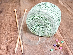 Green Knitting yarn on wooden background