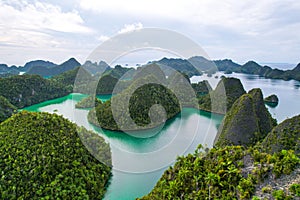 Green Lagoon with limestone islands in Wayag Islands, Raja Ampat, West Papua, Indonesia.