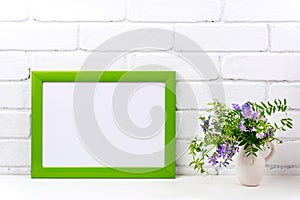 Green landscape frame mockup with purple bird vetch