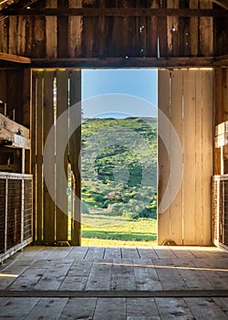 green landscape from inside doorway of rustic barn