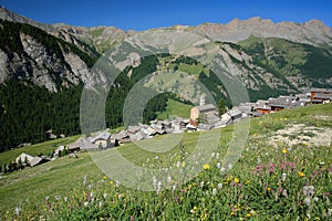 Green landscape with mountain range, pine tree forests and Saint Veran village, Saint Veran photo