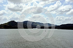 Green landscape of Panama Canal, view from the transiting cargo ship.