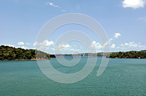 Green landscape of Panama Canal, view from the transiting cargo ship.