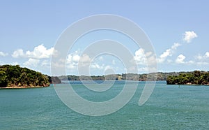 Green landscape of Panama Canal, view from the transiting cargo ship.