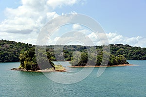 Green landscape of Panama Canal, view from the transiting cargo ship.