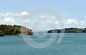 Green landscape of Panama Canal, view from the transiting cargo ship.