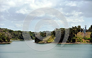 Green landscape of Panama Canal, view from the transiting cargo ship.