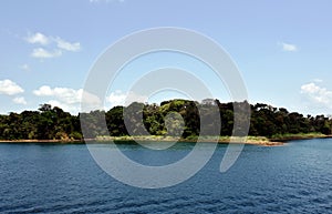 Green landscape of Panama Canal, view from the transiting cargo ship.