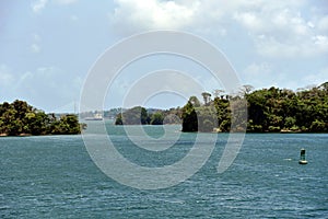 Green landscape of Panama Canal, view from the transiting cargo ship.