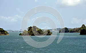 Green landscape of Panama Canal, view from the transiting cargo ship.