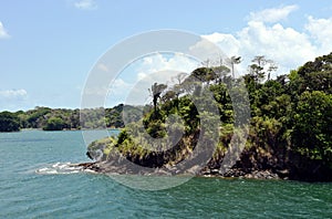 Green landscape of Panama Canal, view from the transiting cargo ship.