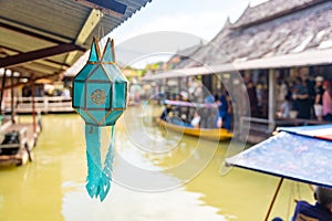 Green lantern in floating open air market with small houses - shops on the pond in Pattaya, Thailand