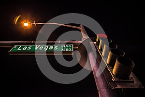 Green Las Vegas Blvd road sign with light pole in the night scene