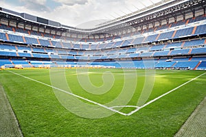 Green lawn with marking at empty outdoor football stadium