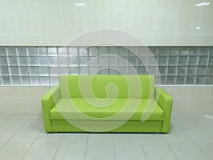Green, leather sofa in the hallway of space.